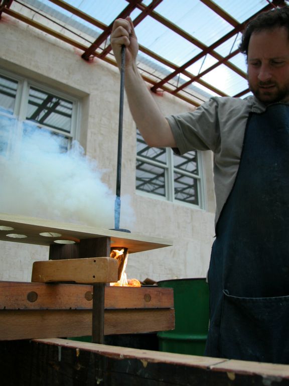 Chris Bono burning open the holes in the new racks for the pipe feet