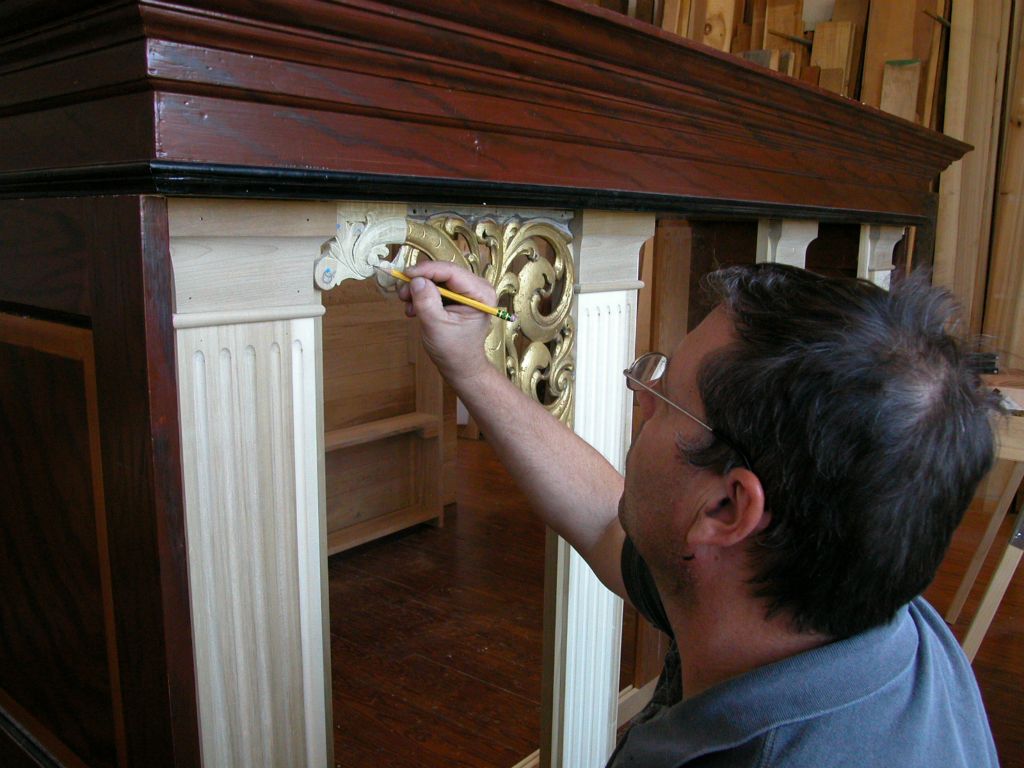 Kelley Blanton fitting the carving with the new piece to the case